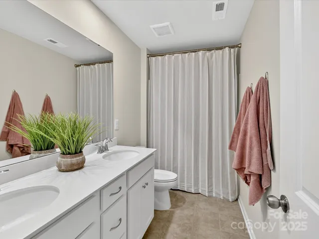 a bathroom with a sink a toilet and a shower