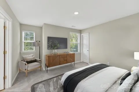 a bedroom with a bed and a couch