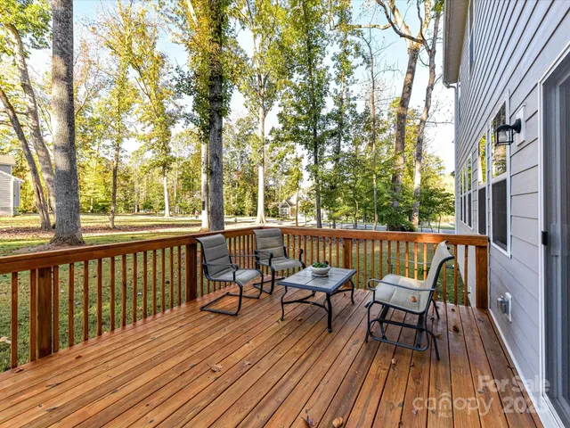 a view of a two chairs with wooden deck and furniture