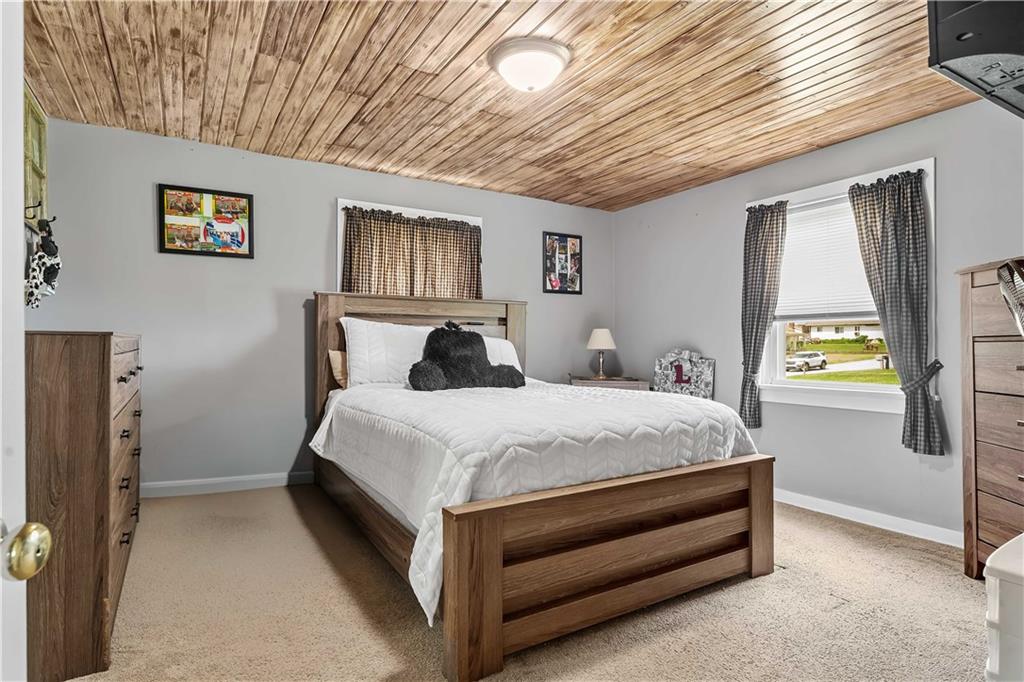 210 Hopwood Fairchance Road Uniontown, PA 15401 - Photo 11 of 28 a bedroom with a bed and a chandelier