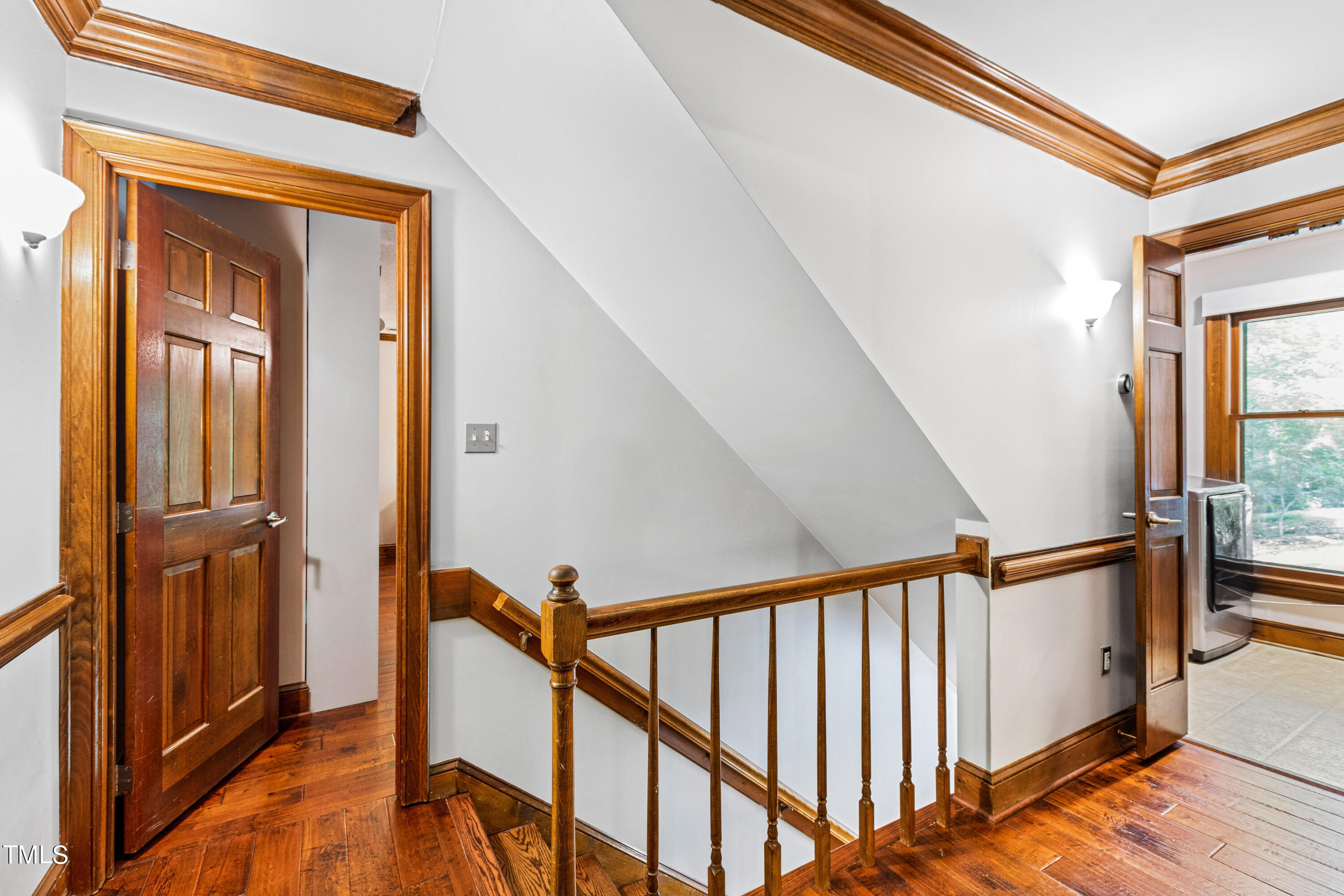 3405 Stallion Court Raleigh, NC 27613 - Photo 24 of 55 a view of a hallway with wooden floor and stairs