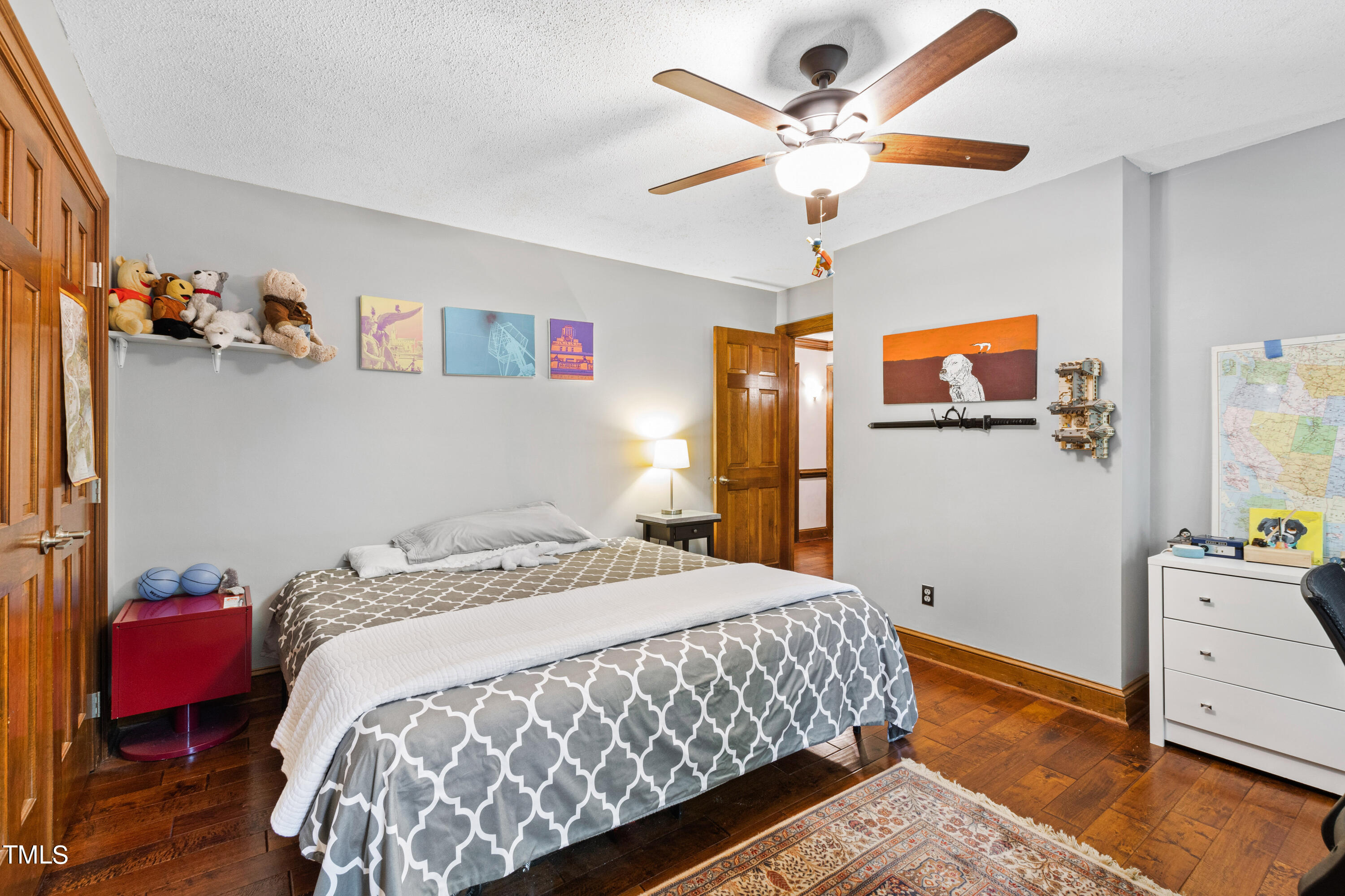 3405 Stallion Court Raleigh, NC 27613 - Photo 43 of 55 a bedroom with a bed and a chandelier