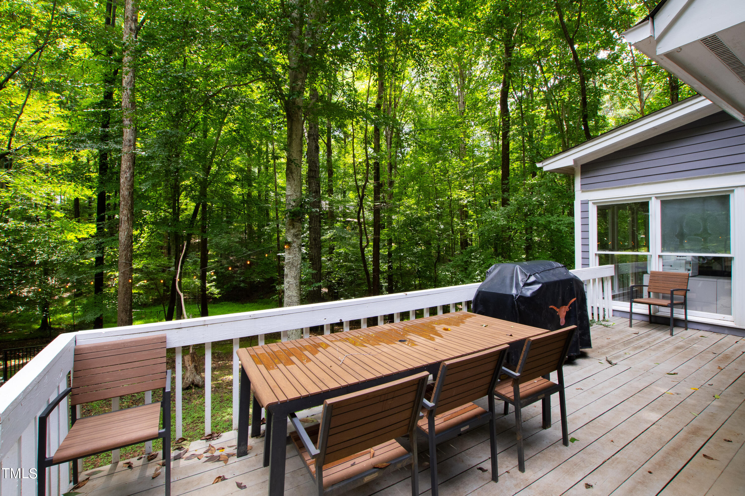 3405 Stallion Court Raleigh, NC 27613 - Photo 45 of 55 a view of a patio with table and chairs and wooden floor