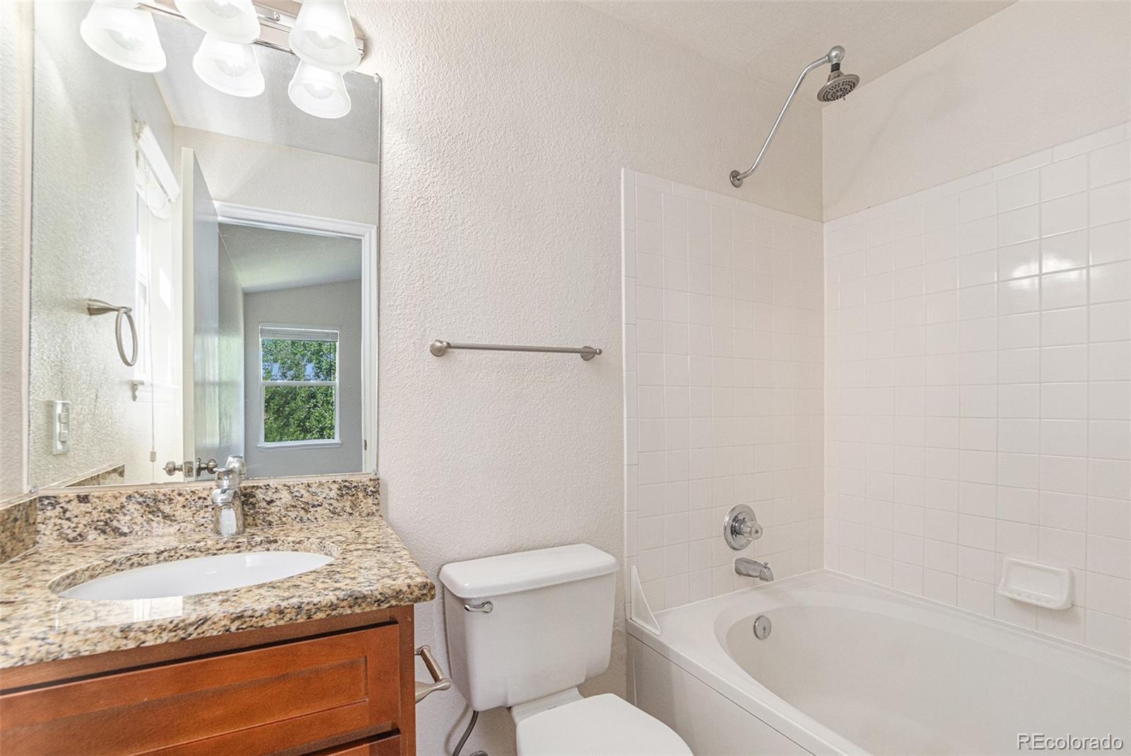 5253 Wangaratta Way Highlands Ranch, CO 80130 - Photo 16 of 43 a bathroom with a granite countertop sink mirror vanity and toilet