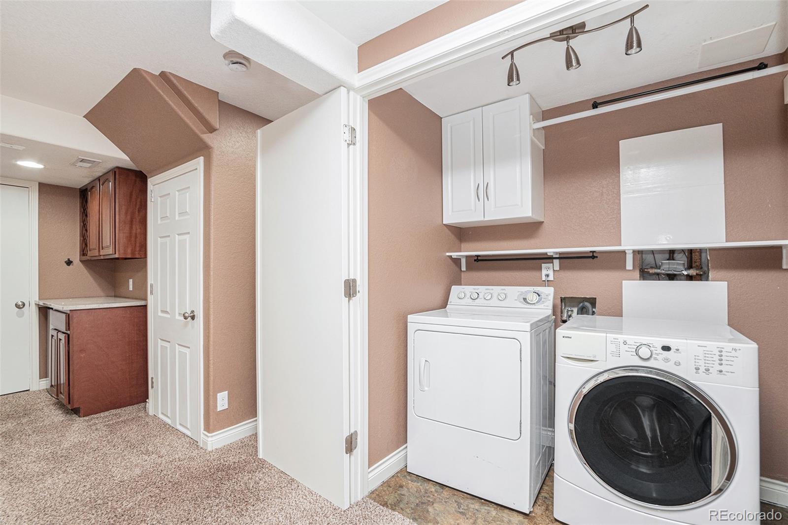 5253 Wangaratta Way Highlands Ranch, CO 80130 - Photo 23 of 43 a view of a kitchen with washer and dryer