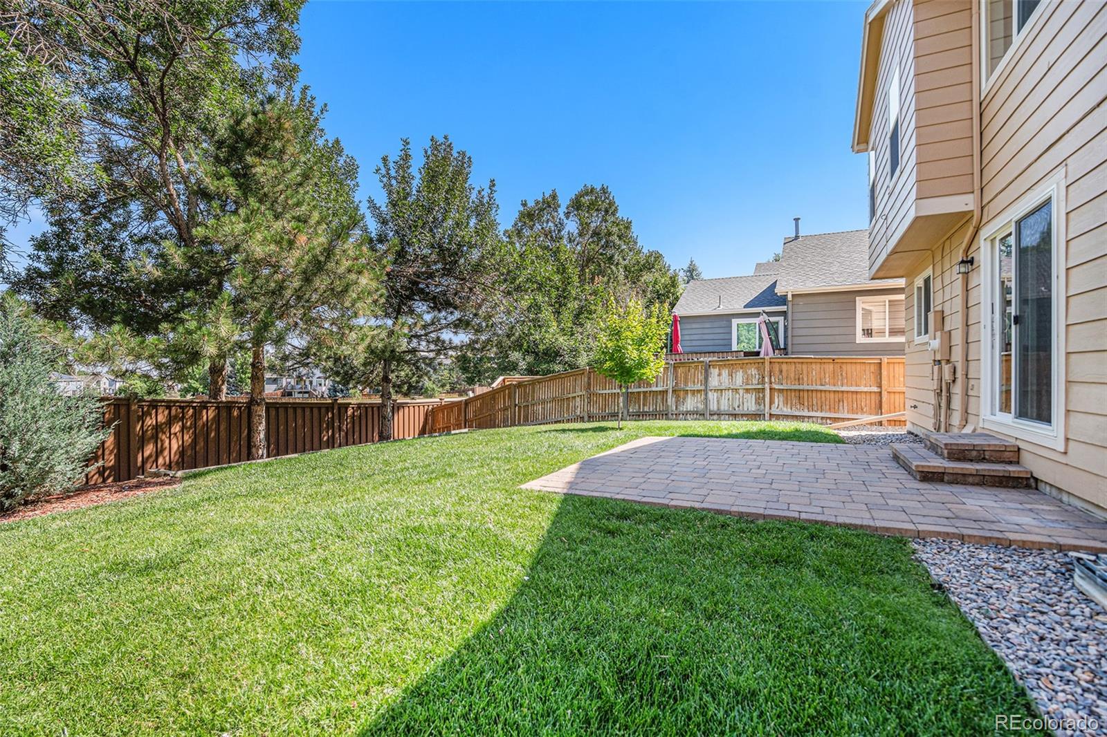 5253 Wangaratta Way Highlands Ranch, CO 80130 - Photo 30 of 43 a view of yard with swimming pool and seating space