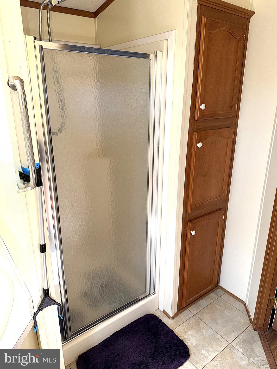 7959 Telegraph Road, Unit 15 Severn, MD 21144 - Photo 16 of 26 a bathroom with a glass door shower and a sink