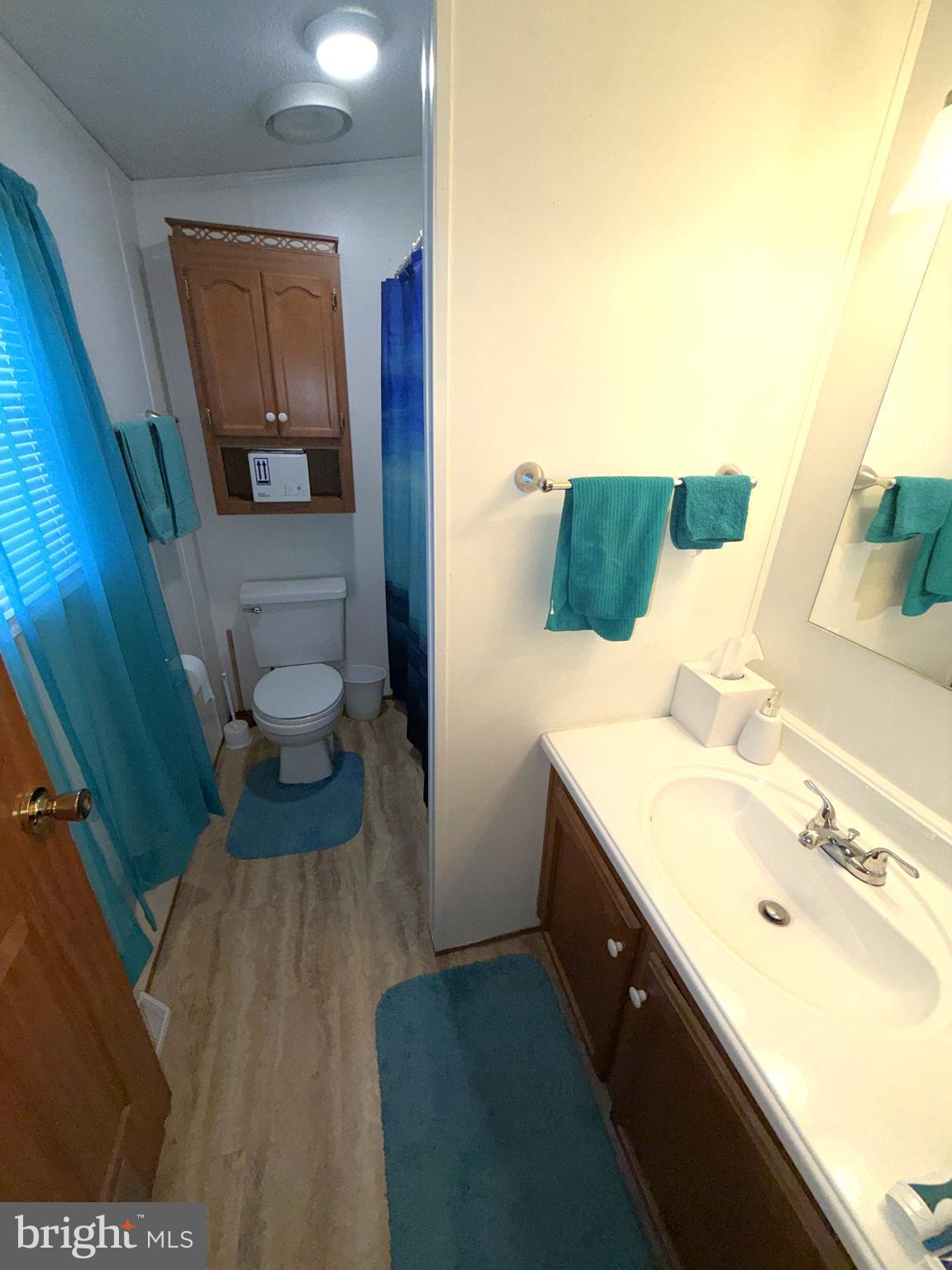 7959 Telegraph Road, Unit 15 Severn, MD 21144 - Photo 20 of 26 a bathroom with a sink and a mirror