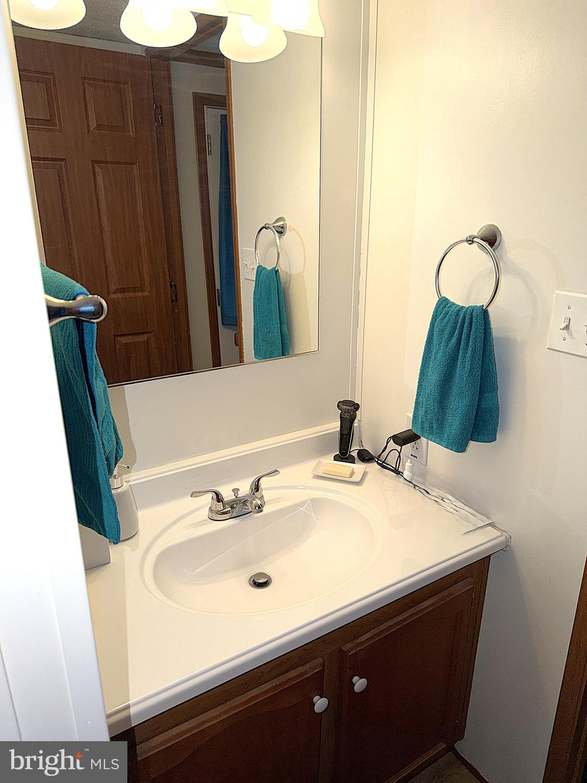 7959 Telegraph Road, Unit 15 Severn, MD 21144 - Photo 21 of 26 a bathroom with a sink and a mirror