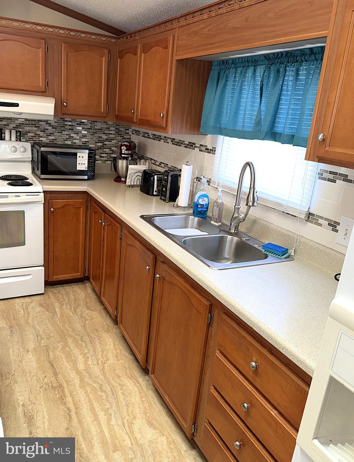 7959 Telegraph Road, Unit 15 Severn, MD 21144 - Photo 4 of 26 a kitchen with a sink and cabinets