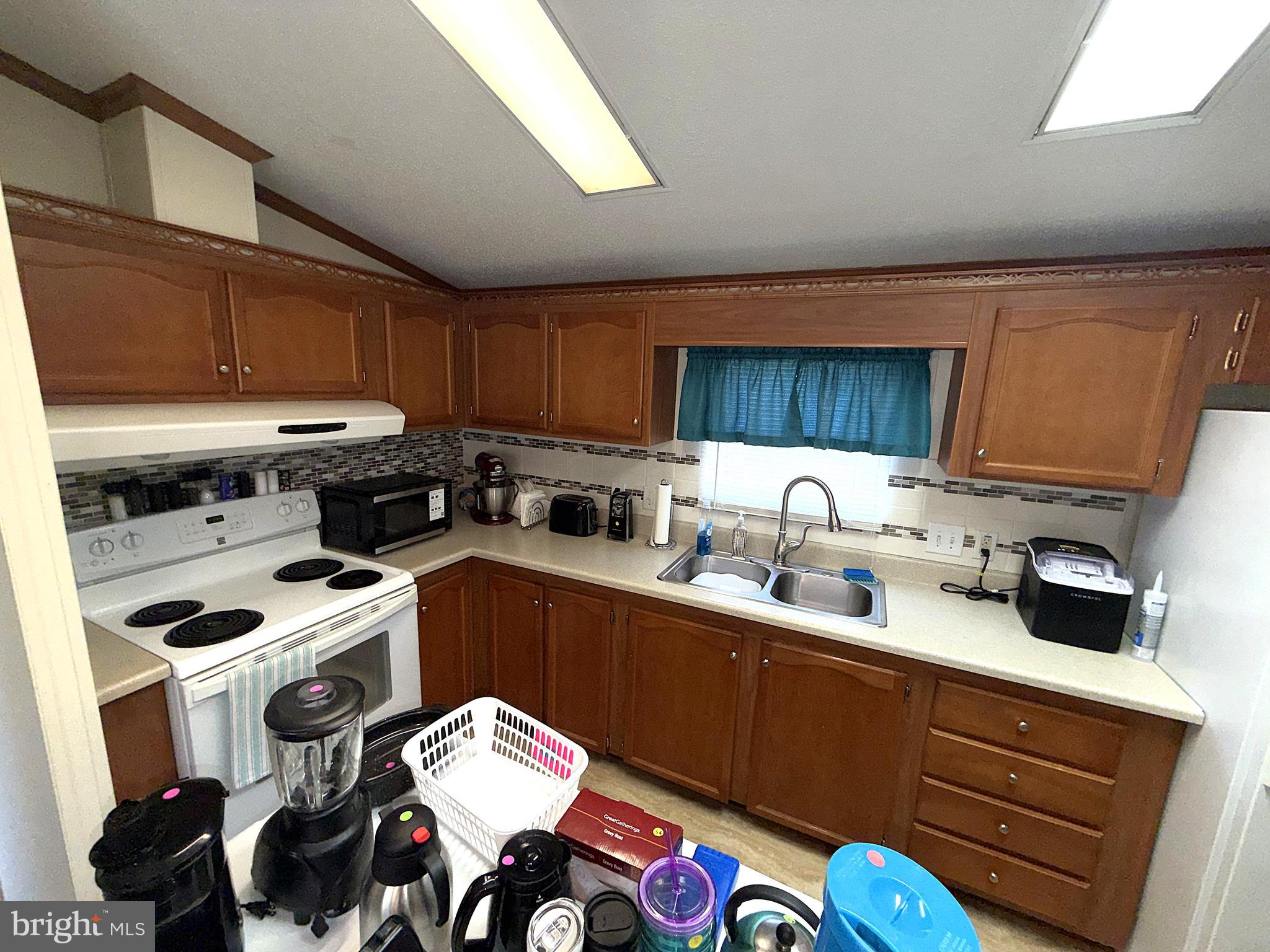 7959 Telegraph Road, Unit 15 Severn, MD 21144 - Photo 8 of 26 a kitchen with a sink appliances and cabinets