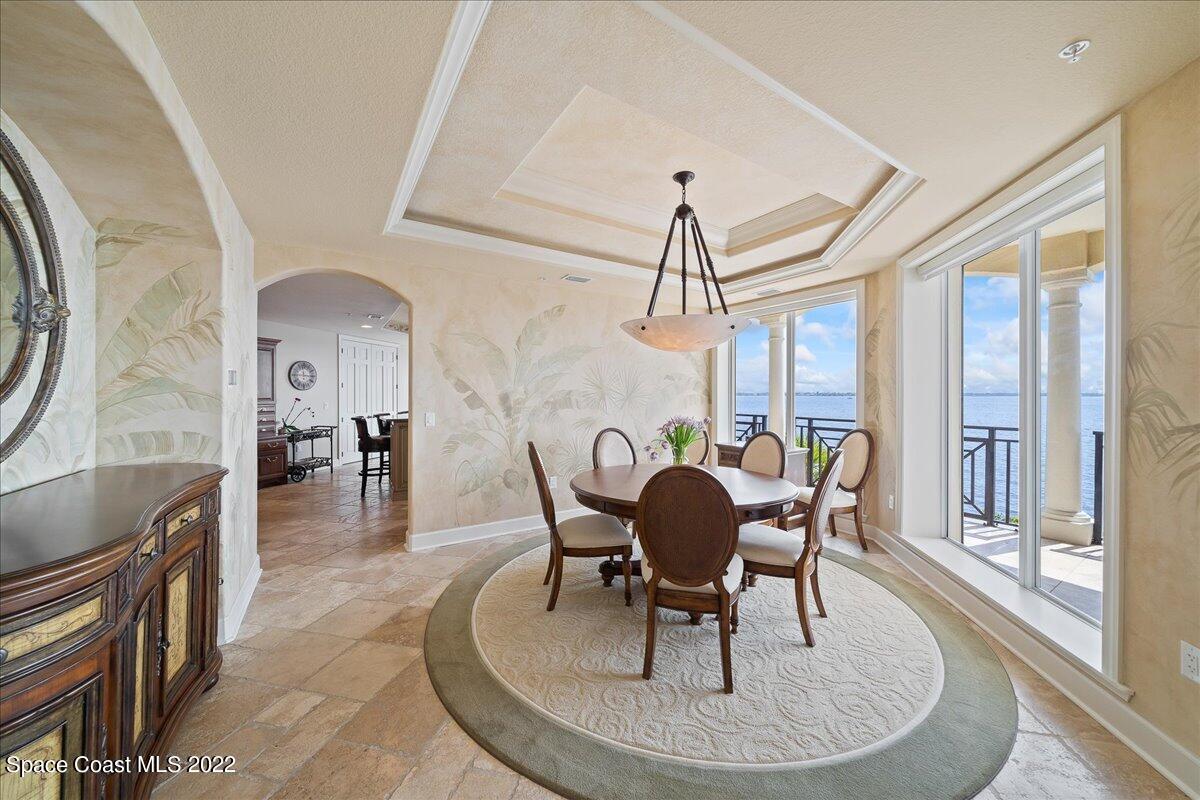 2300 Front Street, Unit 200 Melbourne, FL 32901 - Photo 15 of 92 a dining room with furniture a chandelier and wooden floor