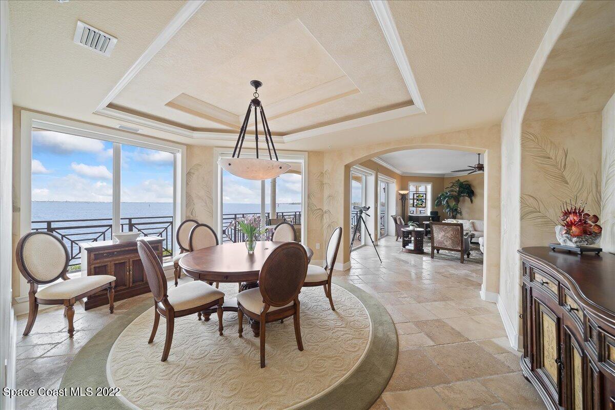 2300 Front Street, Unit 200 Melbourne, FL 32901 - Photo 16 of 92 a dining room with furniture a chandelier and wooden floor