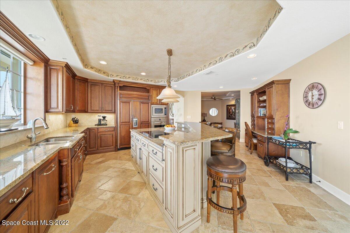 2300 Front Street, Unit 200 Melbourne, FL 32901 - Photo 20 of 92 a kitchen with stainless steel appliances granite countertop a stove top oven a sink dishwasher and cabinets with wooden floor