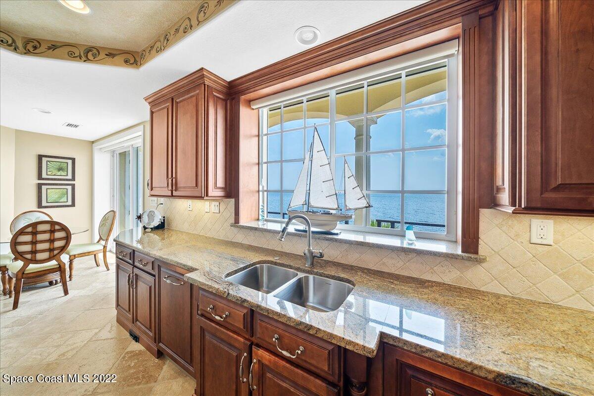 2300 Front Street, Unit 200 Melbourne, FL 32901 - Photo 21 of 92 a kitchen that has a sink and a stove in it