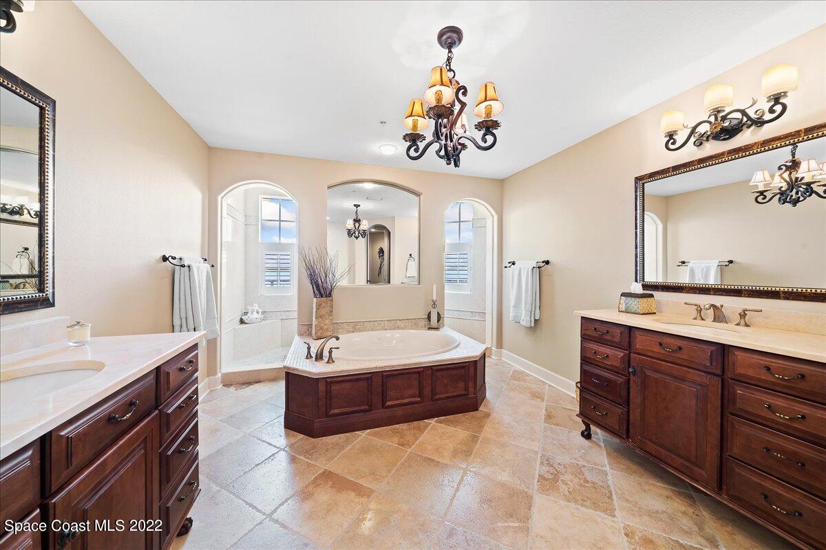 2300 Front Street, Unit 200 Melbourne, FL 32901 - Photo 39 of 92 a spacious bathroom with a sink a mirror and a bathtub