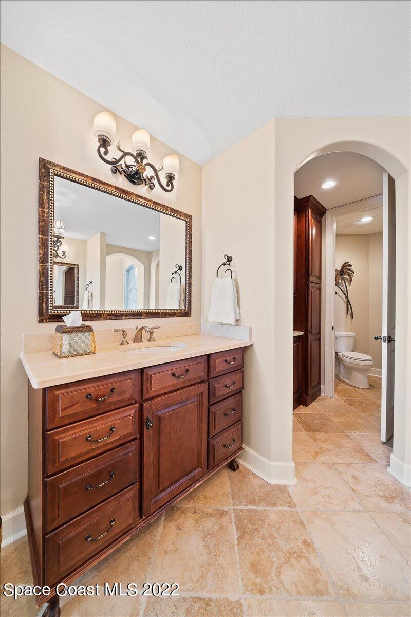 2300 Front Street, Unit 200 Melbourne, FL 32901 - Photo 41 of 92 a bathroom with a sink a large mirror and a vanity