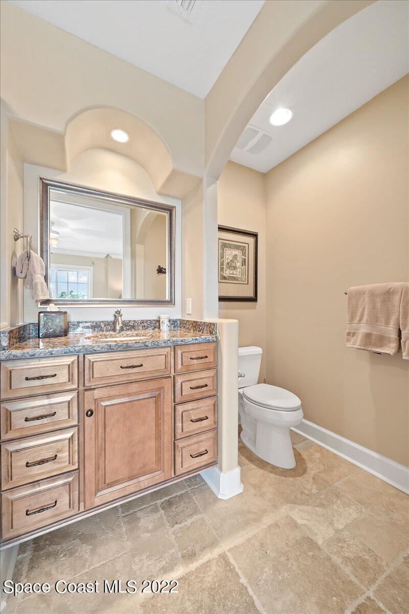 2300 Front Street, Unit 200 Melbourne, FL 32901 - Photo 52 of 92 a spacious bathroom with a toilet a sink and a mirror