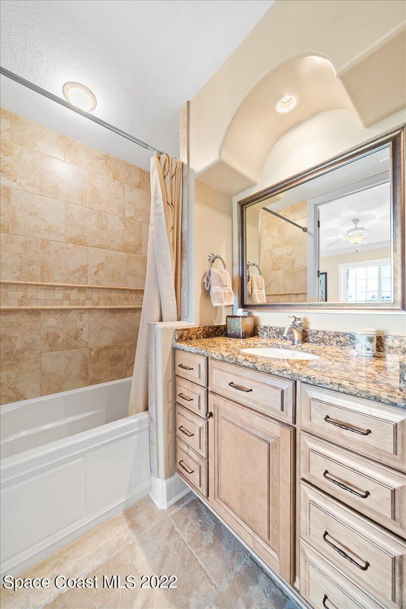 2300 Front Street, Unit 200 Melbourne, FL 32901 - Photo 53 of 92 a bathroom with a granite countertop sink mirror and a