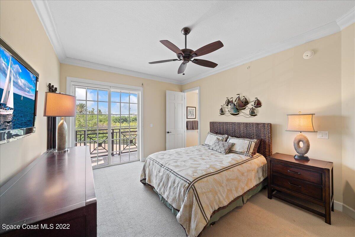 2300 Front Street, Unit 200 Melbourne, FL 32901 - Photo 55 of 92 a bedroom with a large bed and a chandelier