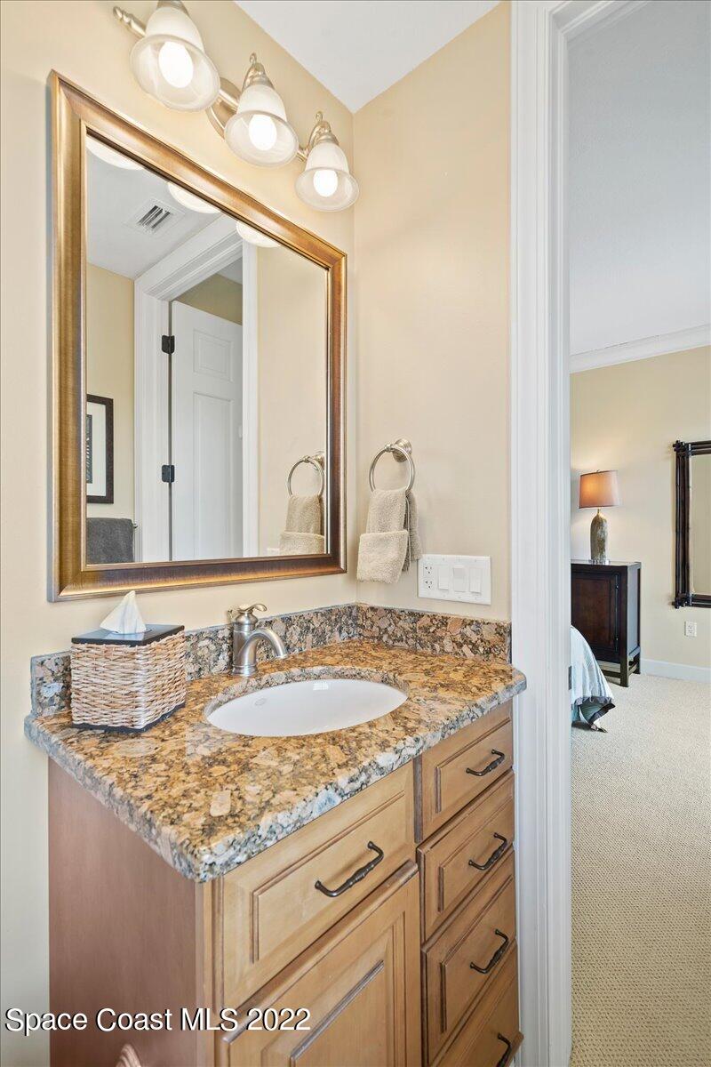 2300 Front Street, Unit 200 Melbourne, FL 32901 - Photo 58 of 92 a bathroom with a granite countertop sink and a mirror