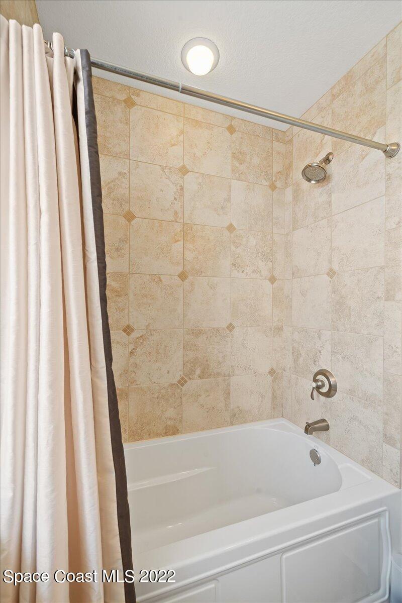 2300 Front Street, Unit 200 Melbourne, FL 32901 - Photo 60 of 92 a bathroom with a shower and a bath tub
