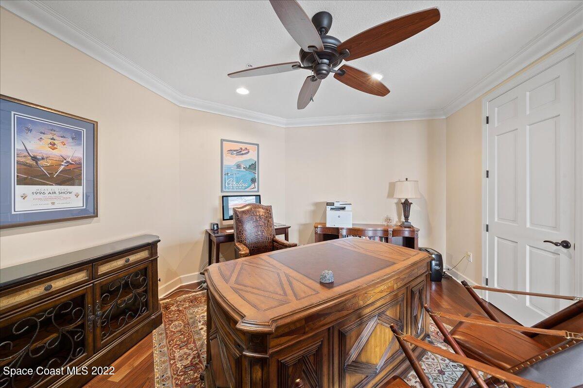2300 Front Street, Unit 200 Melbourne, FL 32901 - Photo 62 of 92 a view of a dining room with furniture and a chandelier fan