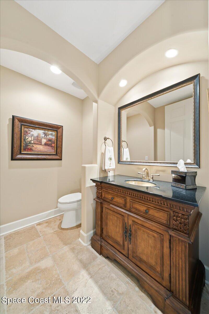 2300 Front Street, Unit 200 Melbourne, FL 32901 - Photo 66 of 92 a spacious bathroom with a toilet a double vanity sink and a mirror