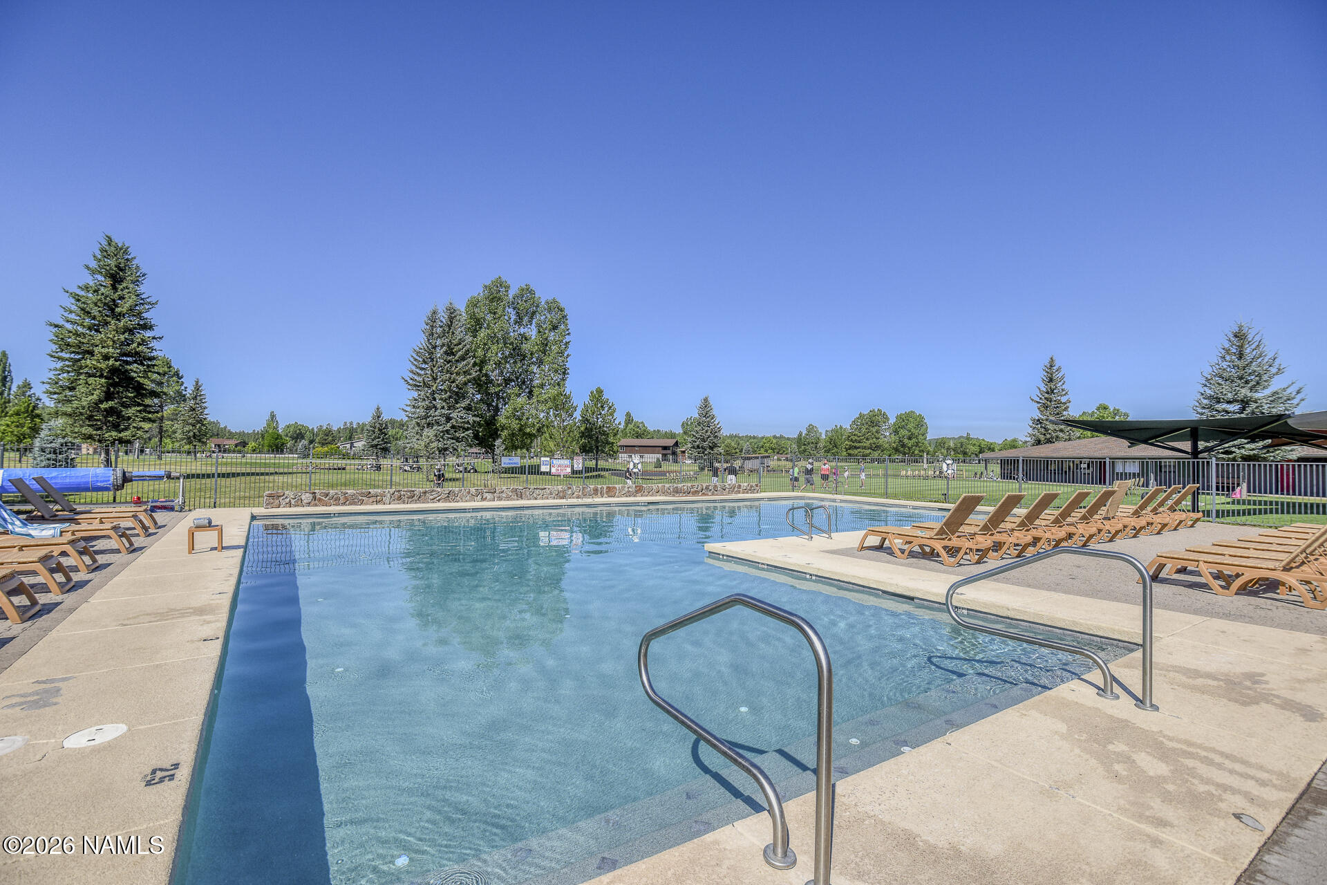 17795 Hopi Road Munds Park, AZ 86017 - Photo 35 of 56 a view of a swimming pool with a lounge chair