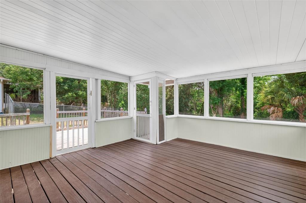 36 Bay Ridge Loop Mascotte, FL 34753 - Photo 24 of 32 a view of an empty room with wooden floor and a window