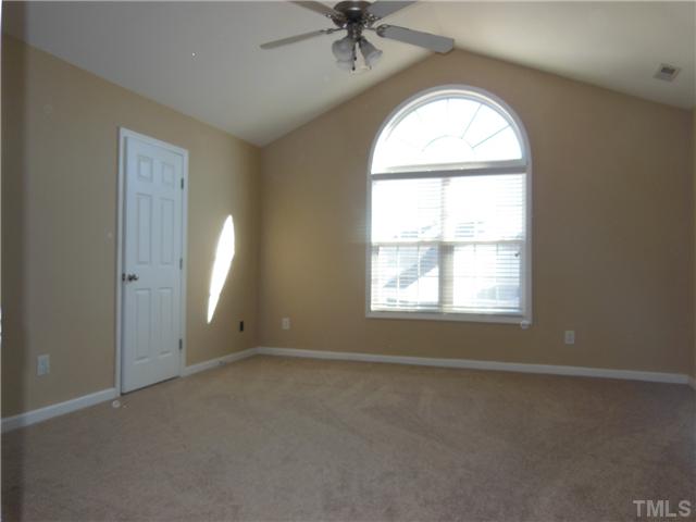 8516 Tierra Del Sol Way Raleigh, NC 27616 - Photo 12 of 20 Master bedroom has a gorgeous window that overlooks back yard. Walk in closet to the left and ceiling fan up top!
