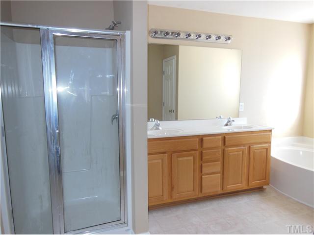8516 Tierra Del Sol Way Raleigh, NC 27616 - Photo 14 of 20 Separate shower and garden tub with dual vanities. Separate toilet room and linen closet all in the master bath suite!