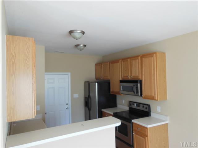 8516 Tierra Del Sol Way Raleigh, NC 27616 - Photo 7 of 20 Lots of cabinet space in the kitchen. There is even a bar ready for your bar stools! All appliances are your to keep with an acceptable offer.