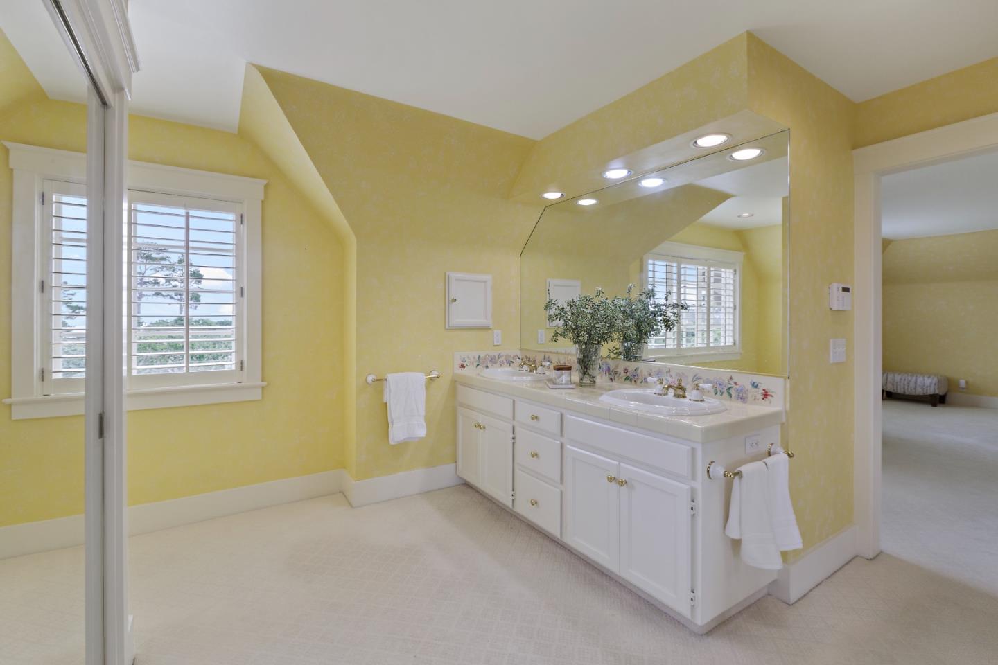 3929 Ronda Road Pebble Beach, CA 93953 - Photo 48 of 88 a bathroom with a double vanity sink and a mirror