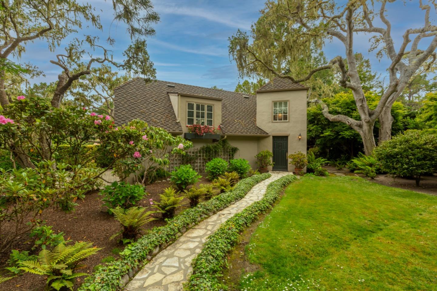 3929 Ronda Road Pebble Beach, CA 93953 - Photo 50 of 88 a front view of a house with a yard and fountain