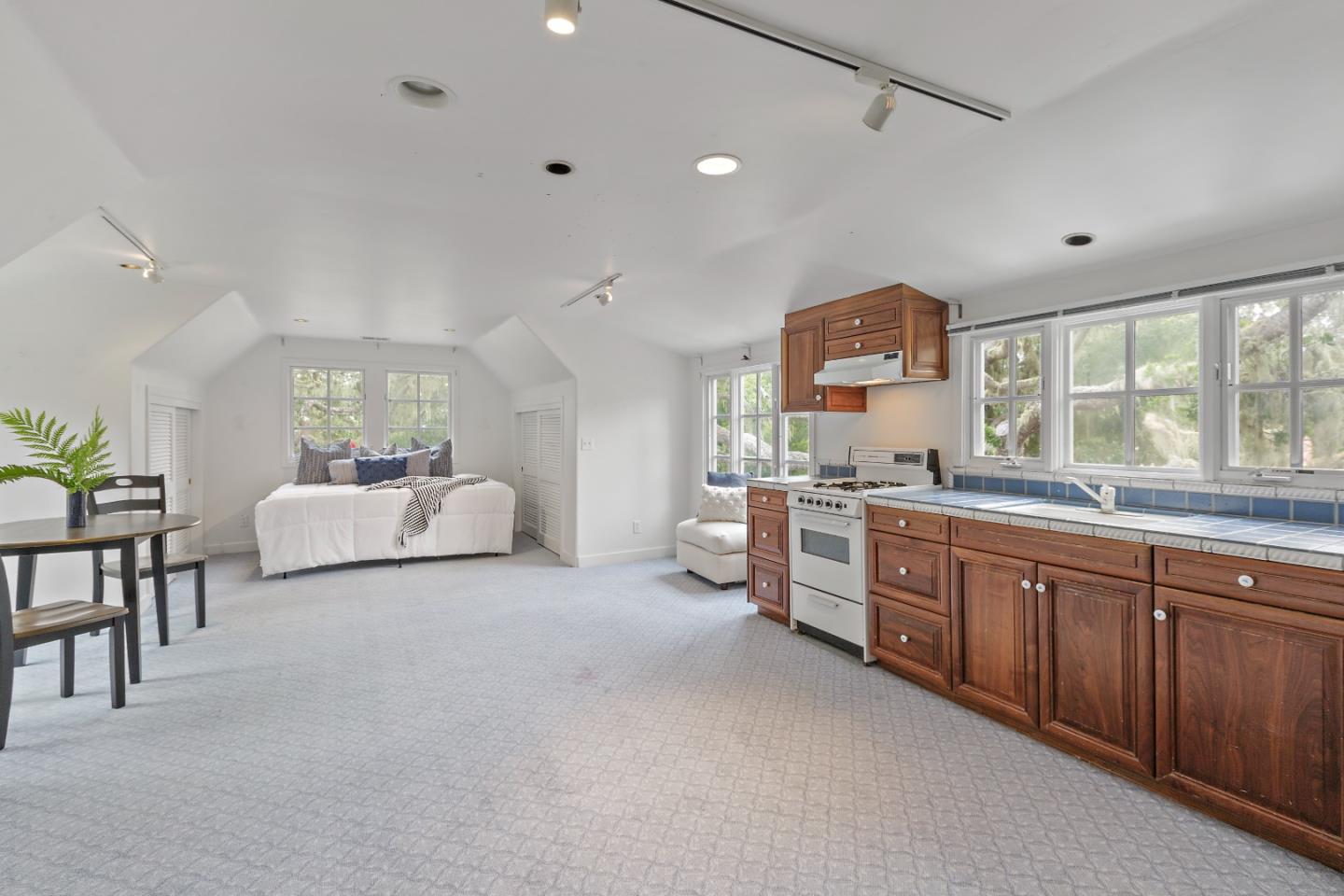 3929 Ronda Road Pebble Beach, CA 93953 - Photo 53 of 88 a large white room with kitchen island a large window and a sink