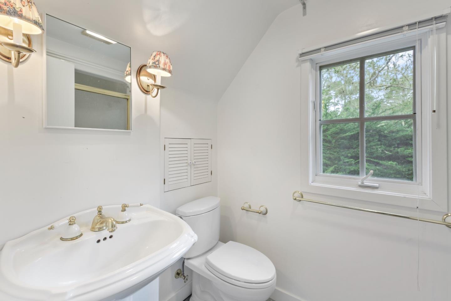 3929 Ronda Road Pebble Beach, CA 93953 - Photo 58 of 88 a bathroom with a toilet a sink and a large mirror