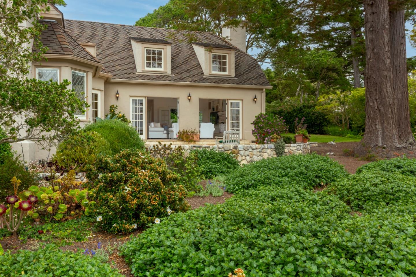 3929 Ronda Road Pebble Beach, CA 93953 - Photo 69 of 88 a front view of a house with garden and trees