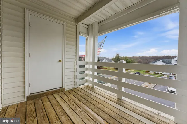 a view of a balcony with wooden floor