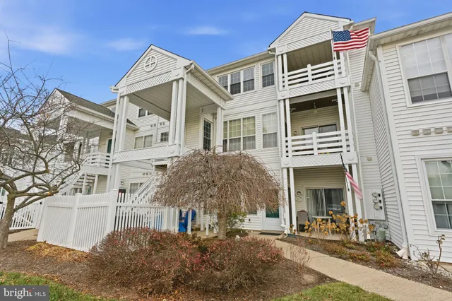 a front view of a building with a yard