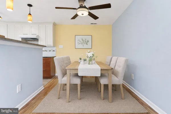 a view of a dining room with furniture and wooden floor