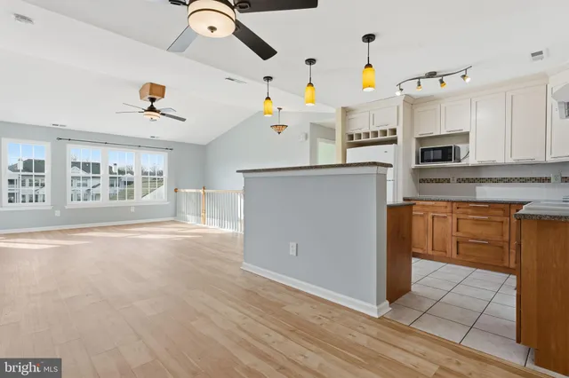 a kitchen with granite countertop a stove and a refrigerator