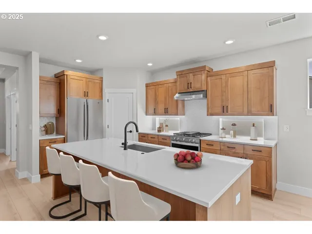 a kitchen with a sink cabinets and wooden floor