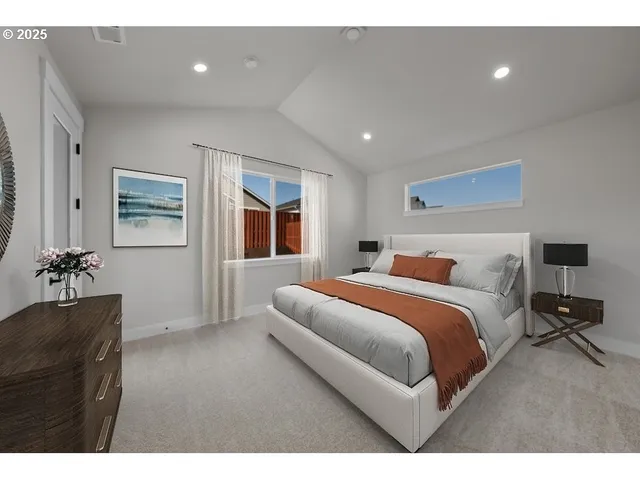 a bedroom with a bed and a large window