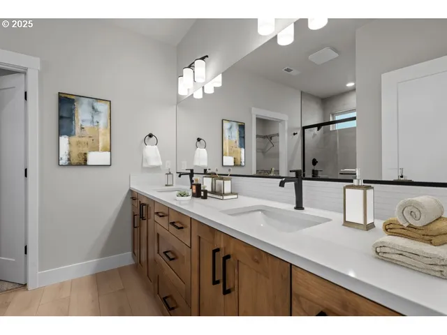a bathroom with a sink double vanity and a mirror