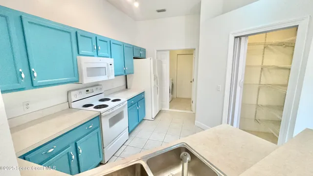 a kitchen with stainless steel appliances a stove a refrigerator and a cabinets