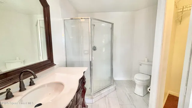 a bathroom with a double vanity sink mirror and shower