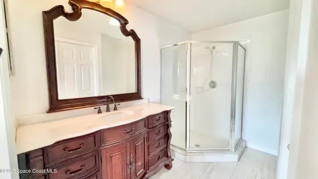 a bathroom with a sink a mirror and a shower