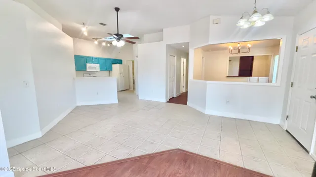 a view of a livingroom with a chandelier fan