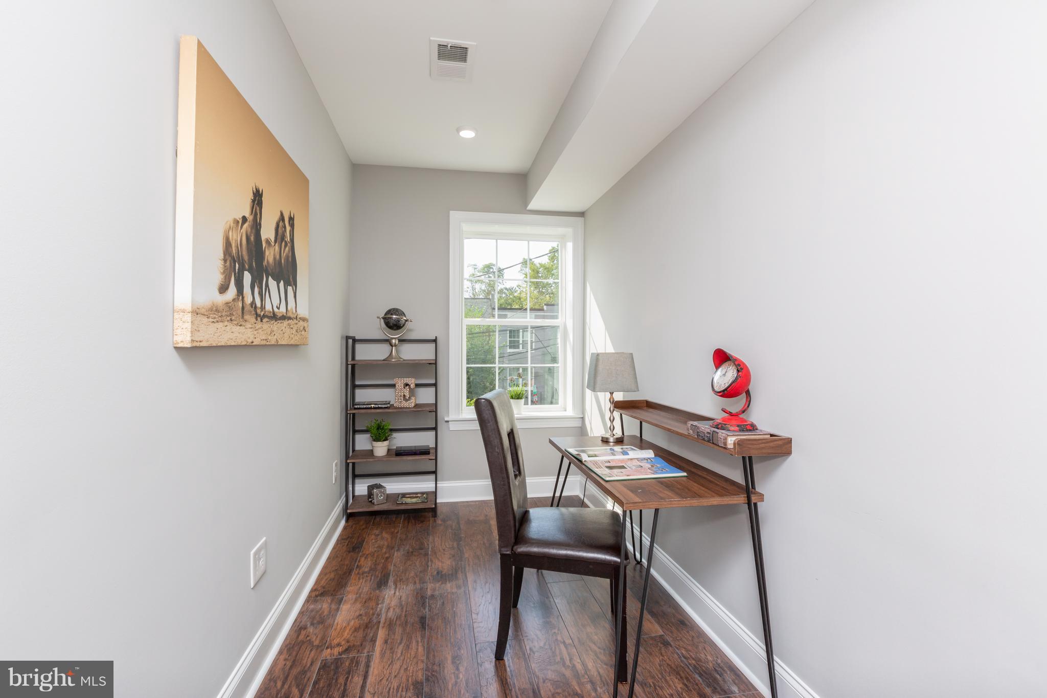 718 Jackson Street Northeast, Unit 1 Washington, DC 20017 - Photo 16 of 26 a view of a dining room with furniture and wooden floor